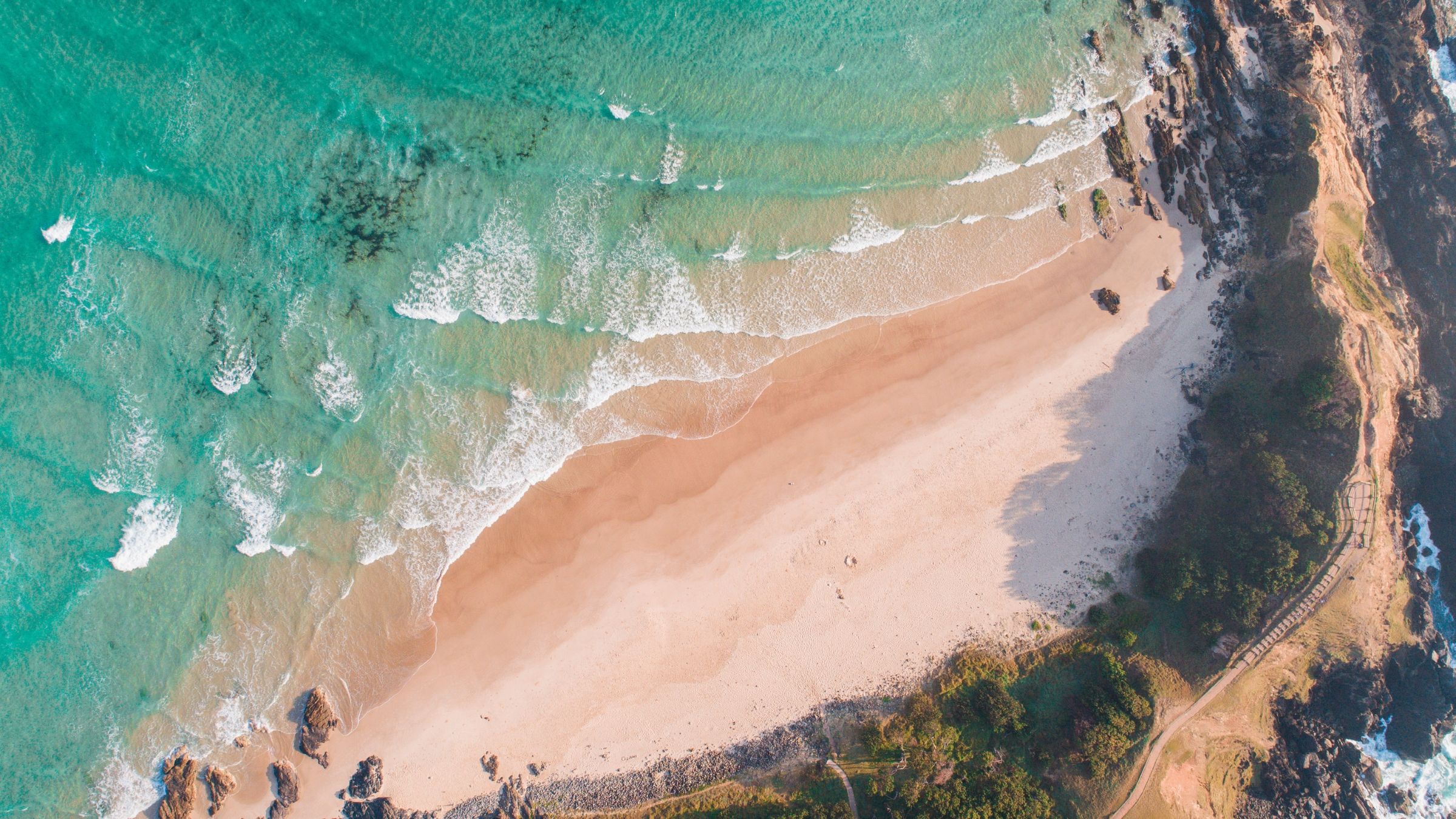 Aerial view of a beach and headland on the Byron Shire coast